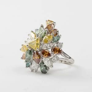 A 14kt white gold and multi-colored diamond ring. Sold $12,000
